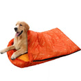 Load image into Gallery viewer, Golden retriever comfortably resting in a bright orange waterproof dog sleeping bag, perfect for outdoor adventures.
