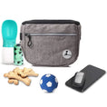 Load image into Gallery viewer, Dog training treat bag with poop bag dispenser, dog toys, phone, and treats for convenient training sessions.
