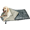 Load image into Gallery viewer, Labrador retriever lounging in a cozy comfort waterproof dog sleeping bag with a playful bone pattern.
