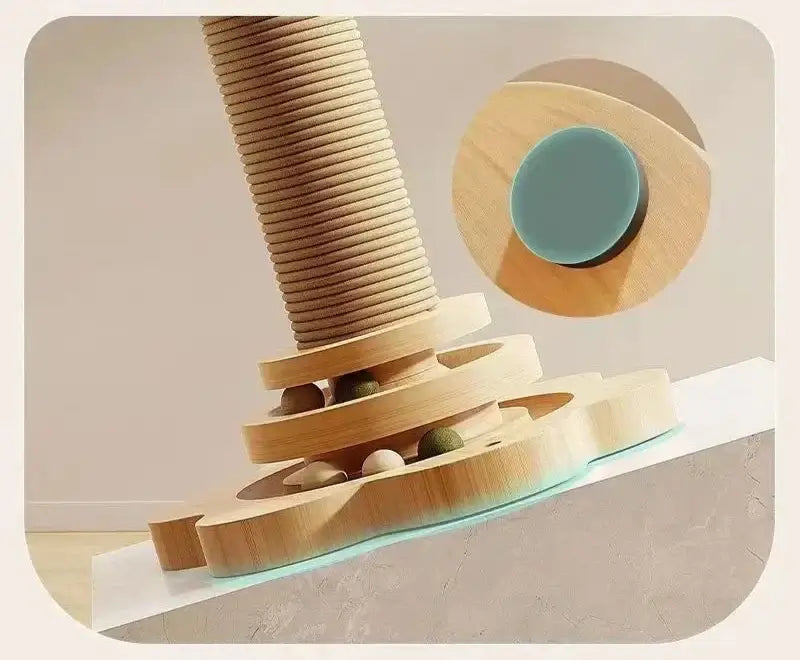 Close-up of a cat climbing frame base featuring a sisal scratching post and wooden design with colorful balls for interactive play.