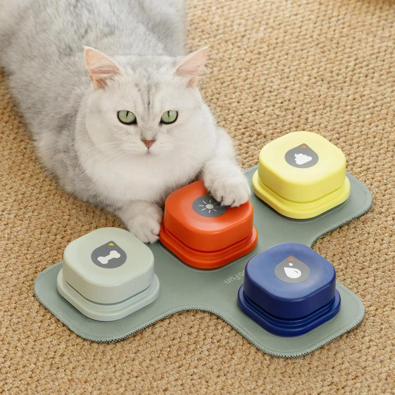 Cat sitting beside Smart Dog Buttons Communication set on a carpet