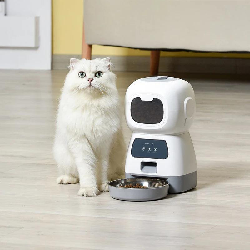 fluffy white cat sitting by Smart Automatic Feeder precise pet feeding with intelligent remote control by littlepawgive