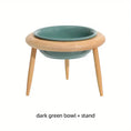 Load image into Gallery viewer, Adjustable dark green ceramic pet bowl on wooden stand for dogs and cats, promoting healthy eating posture.
